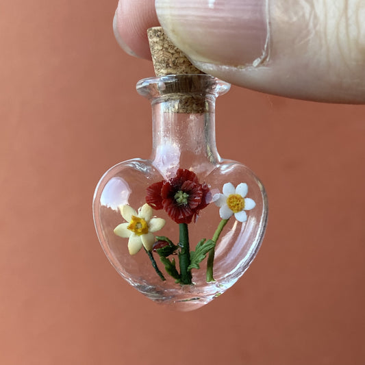 Floral potion bottle terrarium